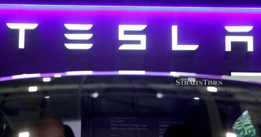 FILE PHOTO: The logo of Tesla on display.  REUTERS/Peter Cziborra/File Photo