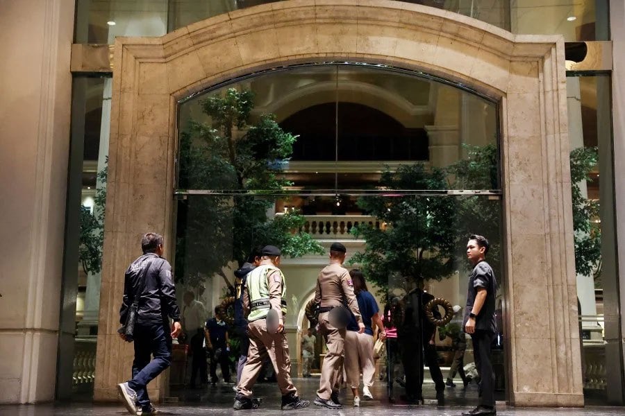 Policemen walk inside the Grand Hyatt Erawan hotel, where it is believed that at least six people have been reported dead, in Bangkok, Thailand today. - REUTERS PIC