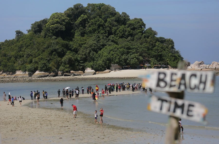 Each year, the mesmerising annual 'parting sea' phenomenon unveils a 400-meter raised sandbank at Pulau Giam, attracting tens of thousands of both local and international tourists to the site in mid-February. - Bernama pic