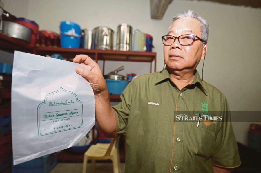 The Masjid Jamek Kampung Baru packets have a ‘Bubur Lambuk Agong’ stamp to prevent others from reselling their porridge. - NSTP/MOHAMAD SHAHRIL BADRI SAALI