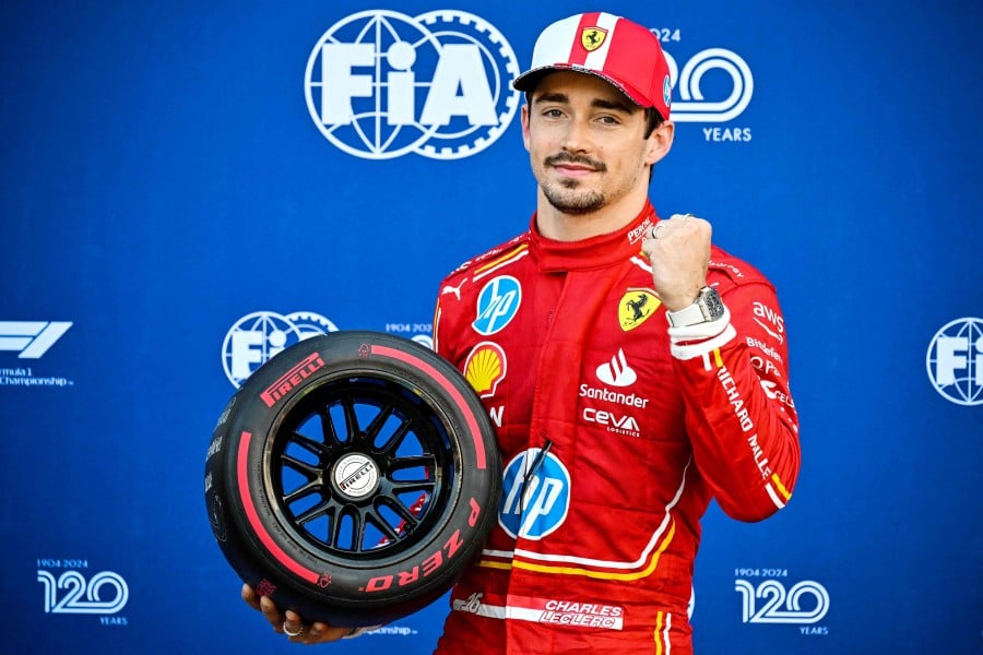 Ferrari's Monegasque driver Charles Leclerc poses after winning the qualifying session of the Formula One Monaco Grand Prix on May 25 2024 at the Circuit de Monaco, on the eve of the race. AFP PIC