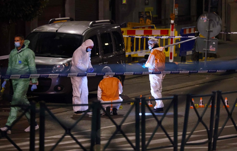 Belgian police officers from the forensic service search for evidence in a street after two people were killed during a shooting in Brussels on October 16, 2023 evening by a suspect who is on the run, the Belgian capital's prosecutor's office said. AFP PIC