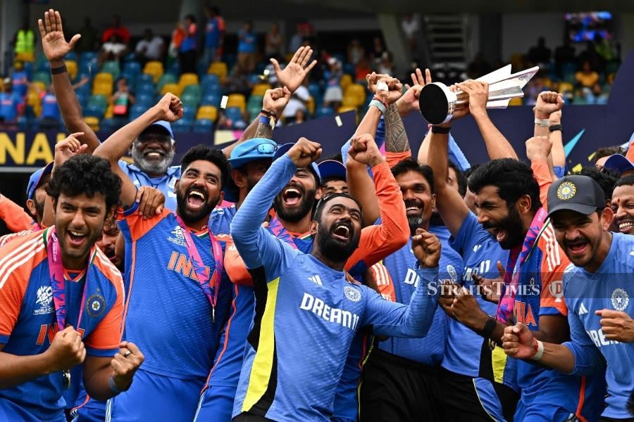 India players celebrate with the trophy after winning the ICC men's Twenty20 World Cup final against South Africa at Kensington Oval in Bridgetown, Barbados, on Sunday. AFP PIC