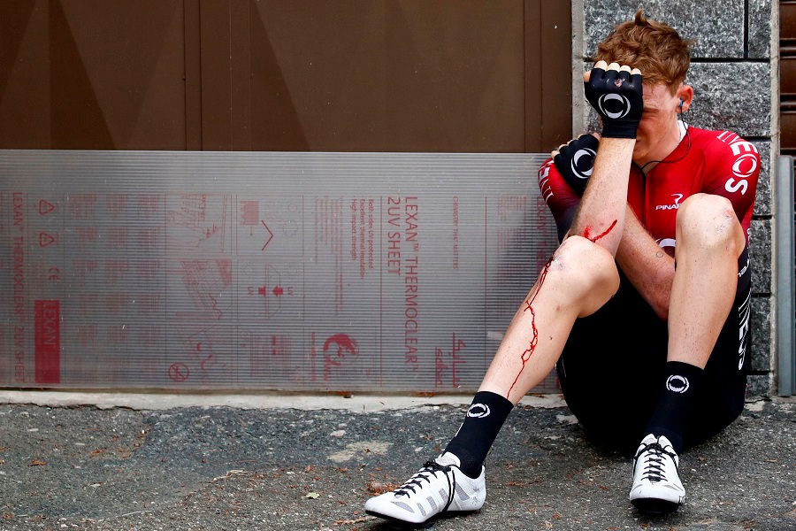 Team Ineos rider Great Britain's Tao Geoghegan Hart sits on the floor after falling during a recent stage 12 of the 102nd Giro d'Italia. -- Image by AFP
