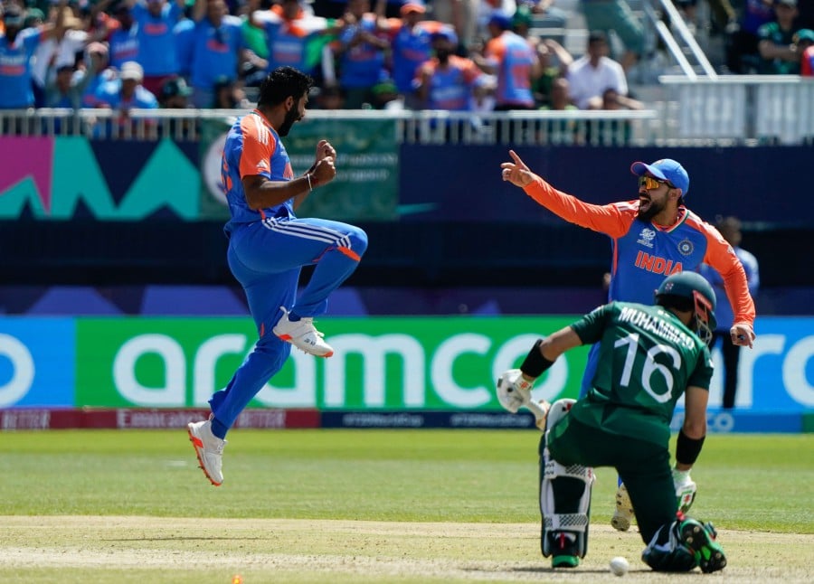 India's Jasprit Bumrah (Left) celebrates after dismissing Pakistan's Mohammad Rizwan during the ICC men's Twenty20 World Cup 2024 group A cricket match at the Nassau County International Cricket Stadium in East Meadow, New York yesterday (June 9). — AFP