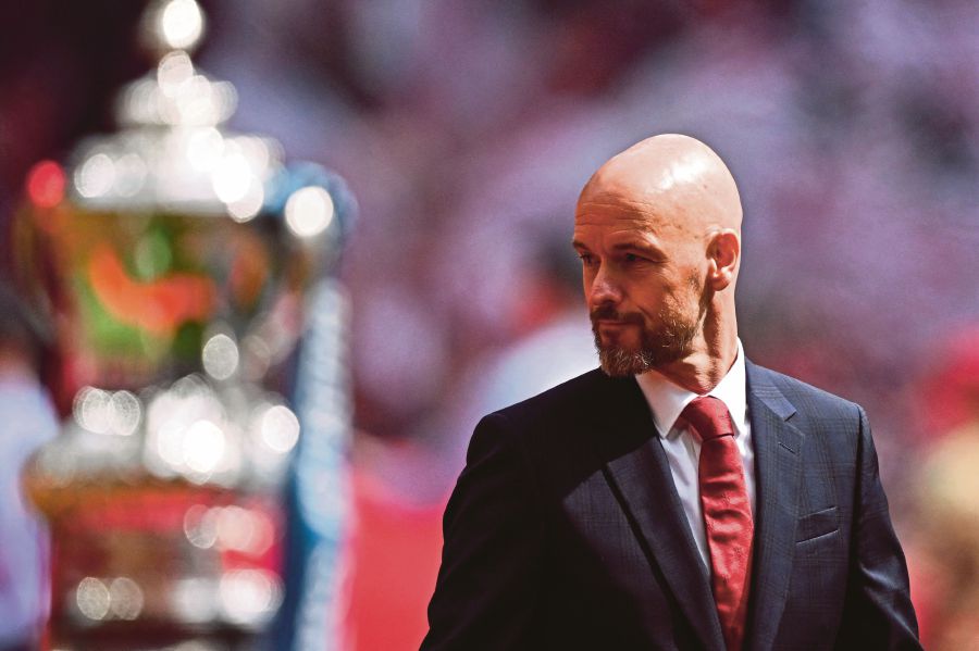Manchester United's Dutch manager Erik ten Hag reacts as he walks past the FA Cup Trophy prior to the English FA Cup final football match between Manchester City and Manchester United at Wembley stadium, in London, on May 25, 2024. - AFP PIC