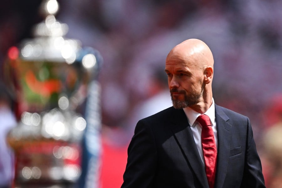 Manchester United's Dutch manager Erik ten Hag reacts as he walks past the FA Cup Trophy prior to the English FA Cup final football match between Manchester City and Manchester United at Wembley stadium, in London, on May 25, 2024. AFP PIC