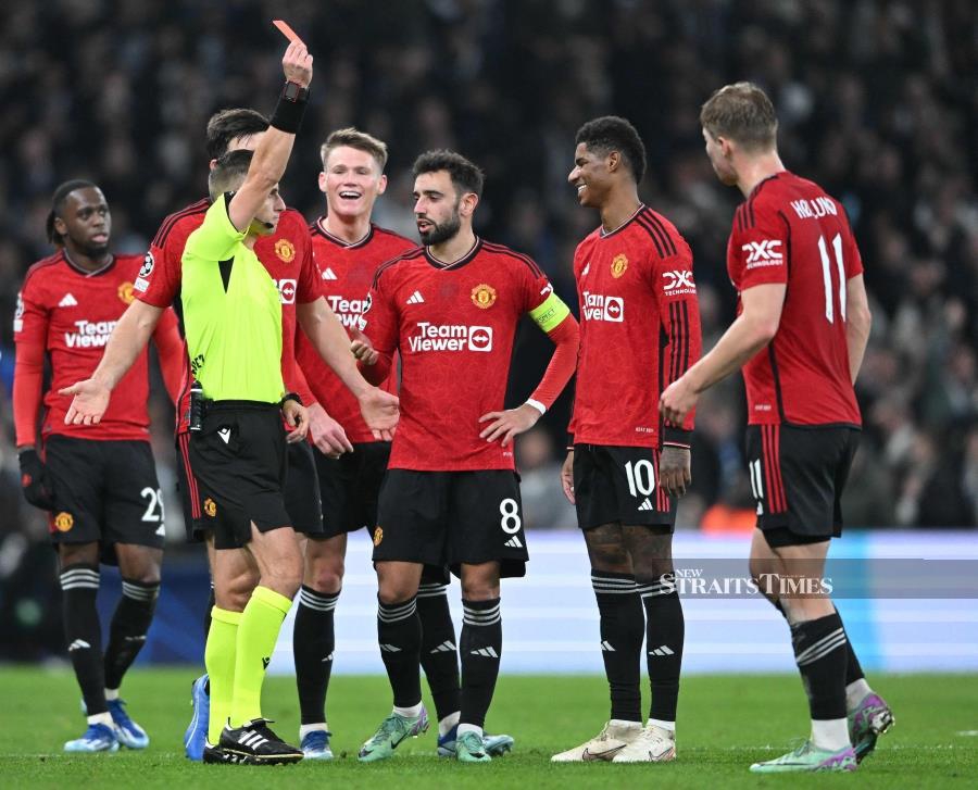 Lithuanian referee Donatas Rumsas shows the red card to Manchester United's Marcus Rashford (second from right) during the UEFA Champions League Group A match against FC Copenhagen on Wednesday. AFP PIC
