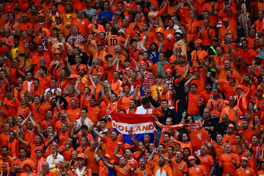 Dutch fans cheer on during the UEFA Euro 2024 Group D football match between Poland and the Netherlands at the Volksparkstadion in Hamburg. (Photo by JOHN MACDOUGALL / AFP)