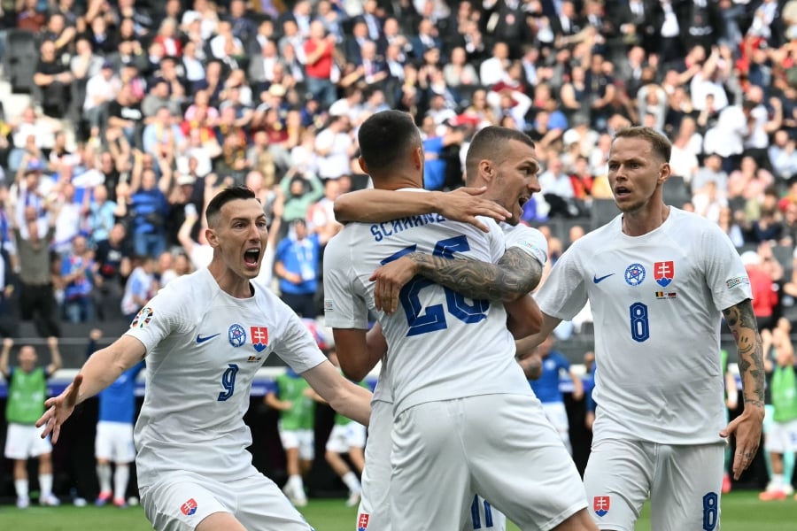 Slovakia's forward (#26) Ivan Schranz celebrates with teammates after scoring their first goal during the UEFA Euro 2024 Group E football match between Belgium and Slovakia at the Frankfurt Arena in Frankfurt am Main. (Photo by THOMAS KIENZLE / AFP)