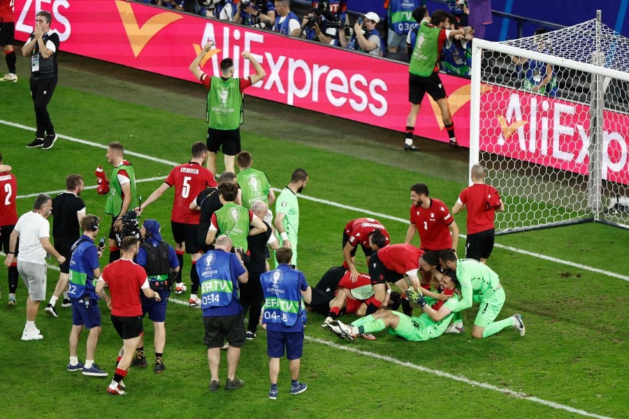 Georgia's players celebrate after the UEFA Euro 2024 Group F football match between Georgia and Portugal at the Arena AufSchalke in Gelsenkirchen on June 26, 2024. AFP PIC