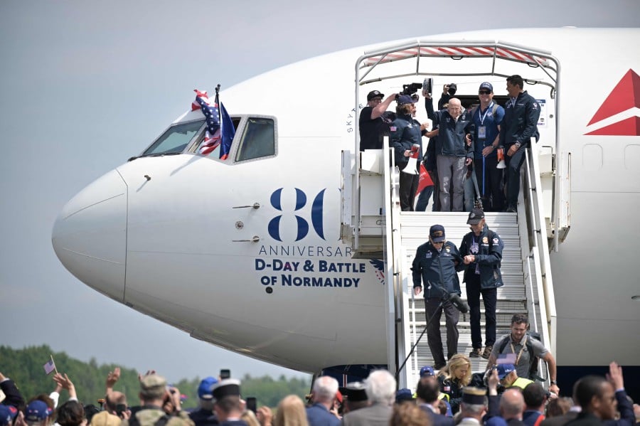 Vererans arrive at the Deauville-Normandie Airport, in Saint-Gatien-des-Bois, northwestern France, on June 3, 2024, ahead of the "D-Day" commemorations marking the 80th anniversary of the World War II Allied landings in Normandy. AFP