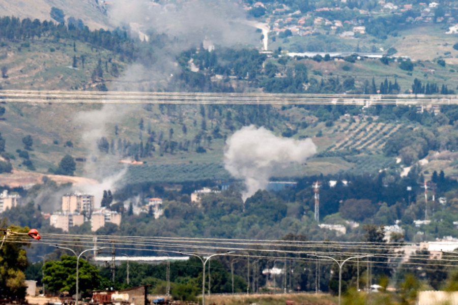 Smoke rises in the northern Israeli northern border city of Kiryat Shmona after rockets were fired from southern Lebanon. (Photo by Jalaa MAREY / AFP)