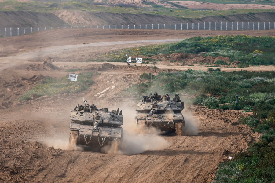 This picture taken from Israel near the border with the Gaza Strip shows Israeli army tanks moving out of Gaza on February 26, 2024, amid the ongoing battles between Israel and the Palestinian group Hamas. AFP PIC