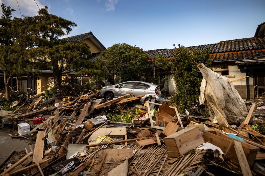 This picture shows a damaged car amid debris in Shiromaru, Ishikawa prefecture on January 5, 2024, after a major 7.5 magnitude earthquake struck the Noto region in Ishikawa prefecture on New Year's Day. AFP PIC