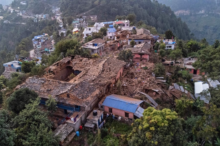 An aerial view shows collapsed houses in the aftermath of an earthquake in Chiuri village at Jajarkot district. (Photo by Prabin RANABHAT / AFP)