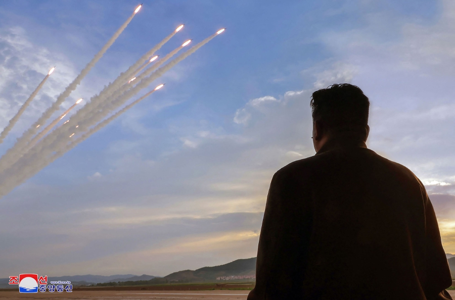 North Korea's leader Kim Jong Un watching a salvo test-fire of 600mm super-large rocket artillery, at an unconfirmed location in North Korea. (Photo by KCNA VIA KNS / AFP) 