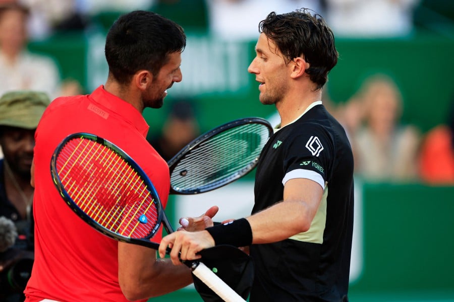 Serbia's Novak Djokovic (L) shakes hands with Norway's Casper Ruud at the end of their Monte Carlo ATP Masters Series Tournament semi final tennis match on the Rainier III court at the Monte Carlo Country Club on April 13, 2024. AFP PIC