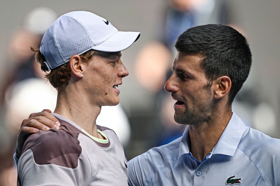 Italy's Jannik Sinner greets Serbia's Novak Djokovic (R) after victory in their men's singles semi-final match on day 13 of the Australian Open tennis tournament in Melbourne on January 26, 2024. AFP PIC