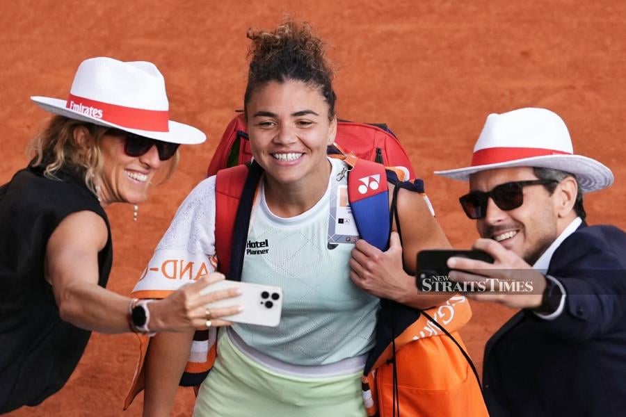 Italy's Jasmine Paolini (centre) poses for a picture as she celebrates after winning her French Open semi-final against Russia's Mirra Andreeva at the Roland Garros Complex in Paris on Thursday. AFP PIC 
