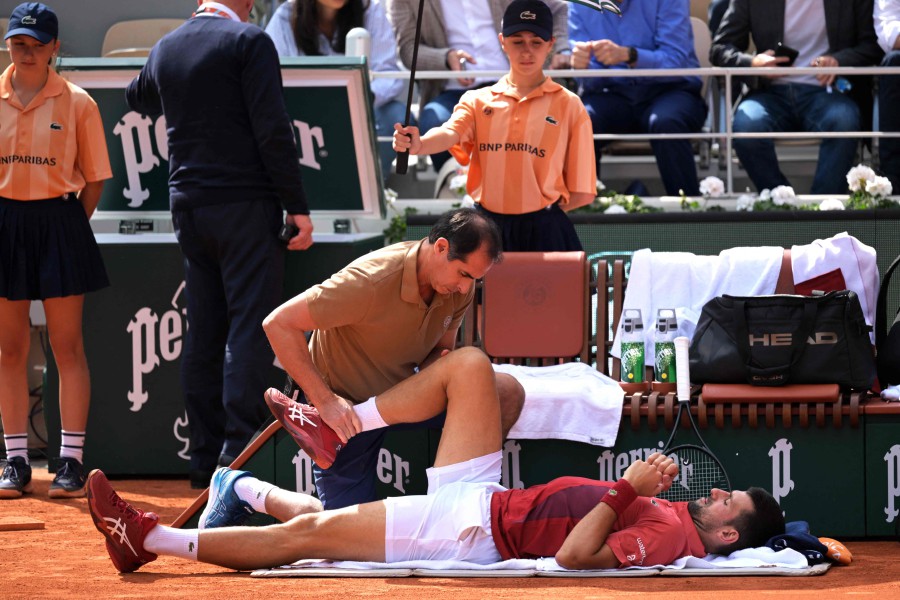 Serbia's Novak Djokovic receives medical treatment during his men's singles round of sixteen match against Argentina's Francisco Cerundolo on Court Philippe-Chatrier on day nine of the French Open tennis tournament at the Roland Garros Complex in Paris on June 3, 2024. AFP PIC
