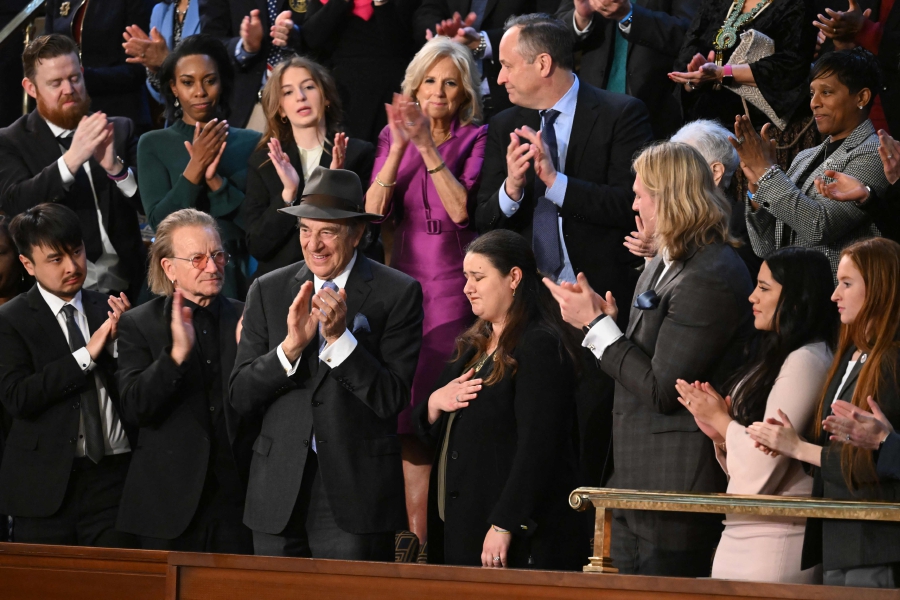 Attendees, including US First Lady Jill Biden, US Second Gentleman Doug Emhoff, Irish singer-songwriter Bono, Paul Pelosi, and Brandon Tsay applaud Ukrainian Ambassador to the US Oksana Markarova as US President Joe Biden delivers the State of the Union address in the House Chamber of the US Capitol in Washington, DC. (Photo by SAUL LOEB / AFP)