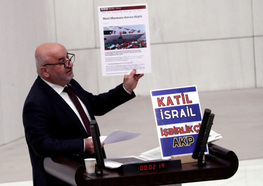 Turkey's opposition Felicity Party (Saadet) lawmaker Hasan Bitmez makes a speech at a stand with a placard, criticizing the government's policy towards Israel, at the Turkish parliament in Ankara, Turkey December 12, 2023. The placard reads: "Murderer Israel, collaborator AK Party". REUTERS PIC