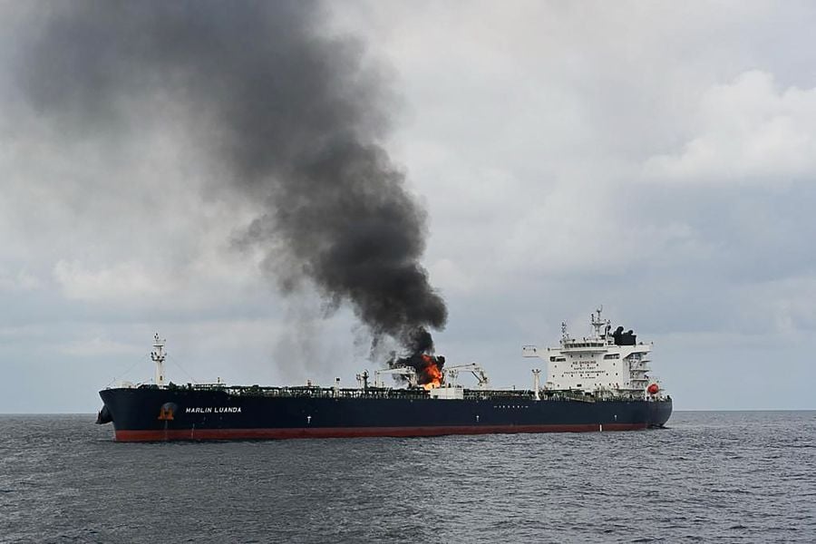 This handout photograph taken on January 27, 2024 and released by the Indian Ministry of Defence shows smoke billowing from the British oil tanker MV Merlin Luanda after the Indian Navy deployed the INS Visakhapatnam following a distress call by the vessel while transiting through the Gulf of Aden in the Arabian Sea. (Photo by INDIAN MINISTRY OF DEFENCE / AFP)