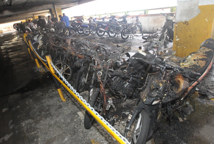 Up to 13 motorcycles parked on the third level of the Terminal One shopping mall here were destroyed in a fire which broke out at 1pm today. Pix by Hazreen Mohamad