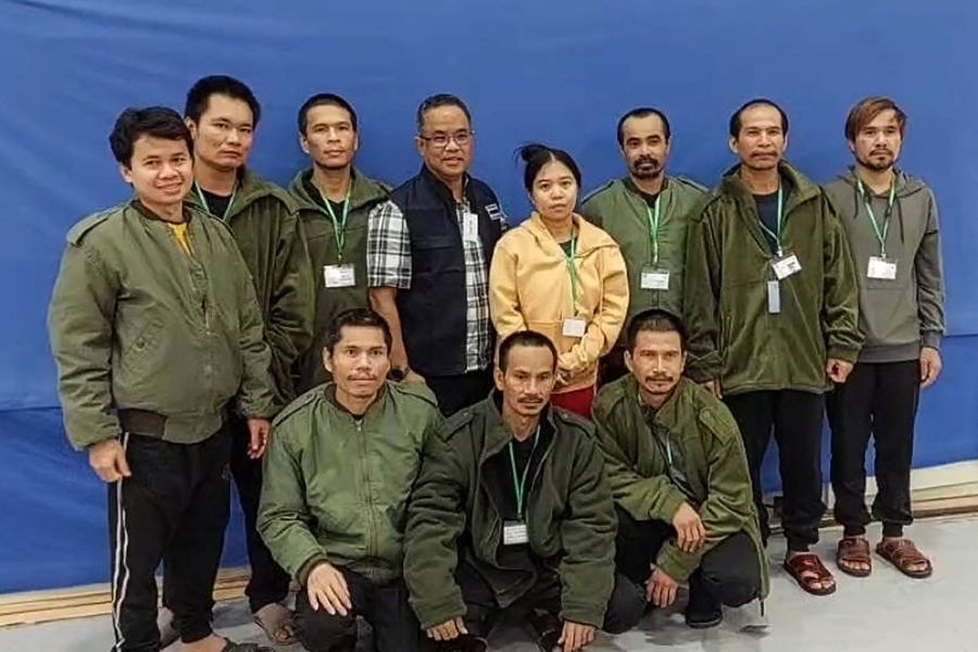 This undated and unlocated handout photo released on November 25, 2023 by Thailand's Ministry of Foreign Affairs shows a Thai official (C) posing for a group photo with 10 released Thai hostages in Israel, after they were freed by Hamas. Ten Thai hostages kidnapped during Hamas's October 7 raids into Israel were released on November 24, 2023, according to the Thai and Israeli governments, hours after a truce in the Israel-Hamas war began. (Photo by Handout / THAILAND'S MINISTRY OF FOREIGN AFFAIRS / AFP) 