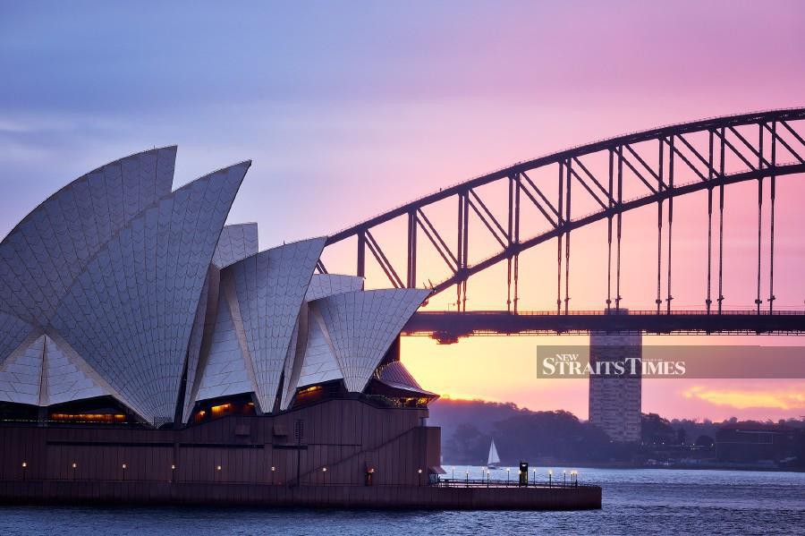 The Sydney Opera House and Sydney Harbour Bridge at sunrise