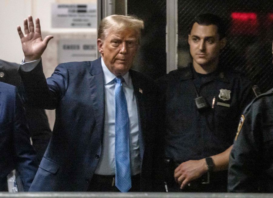 Former US President Donald Trump walks back to the courtroom following a lunch break in his trial for allegedly covering up hush money payments linked to extramarital affairs, at Manhattan Criminal Court in New York City. - AFP pic