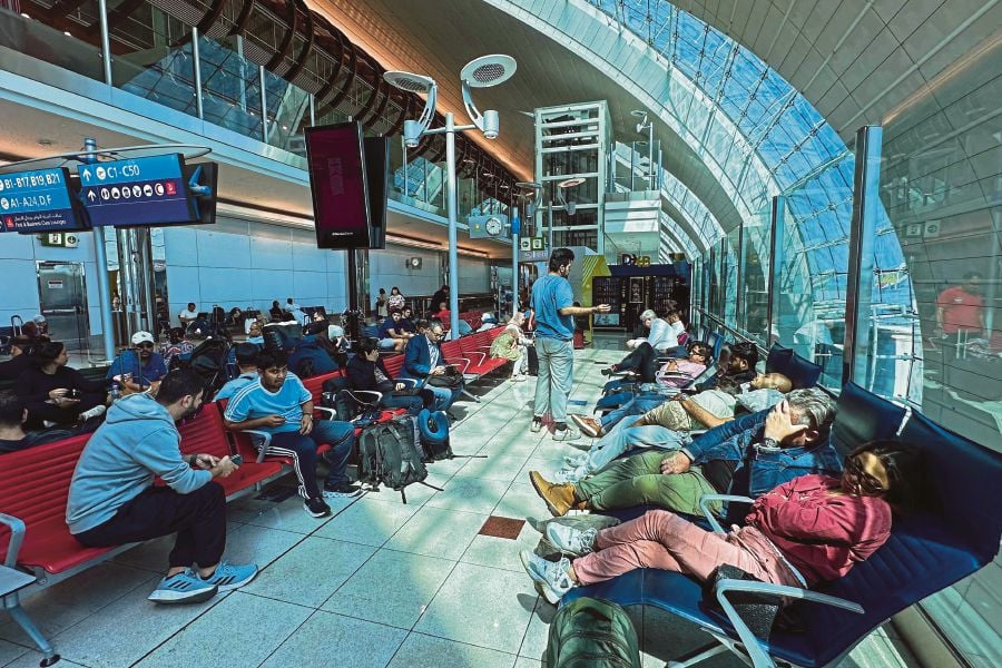 Dubai's major international airport diverted scores of incoming flights on April 16 as heavy rains lashed the United Arab Emirates, causing widespread flooding around the desert country. (Photo by AFP)