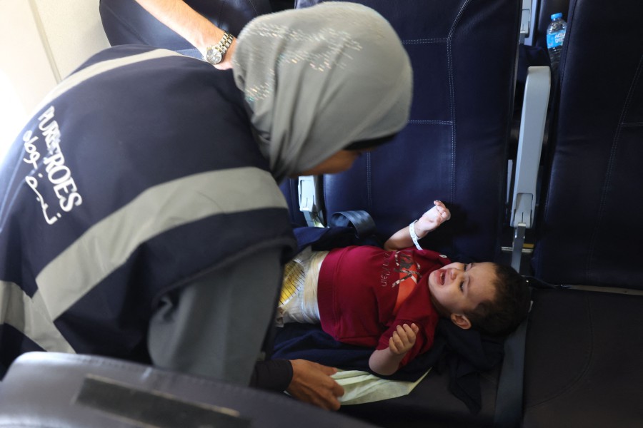 A volunteer transports a wounded Palestinian child off the plane upon their arrival in Abu Dhabi on November 18, 2023, after being evacuated from Gaza as part of a humanitarian mission organised by the United Arab Emirates. AFP PIC