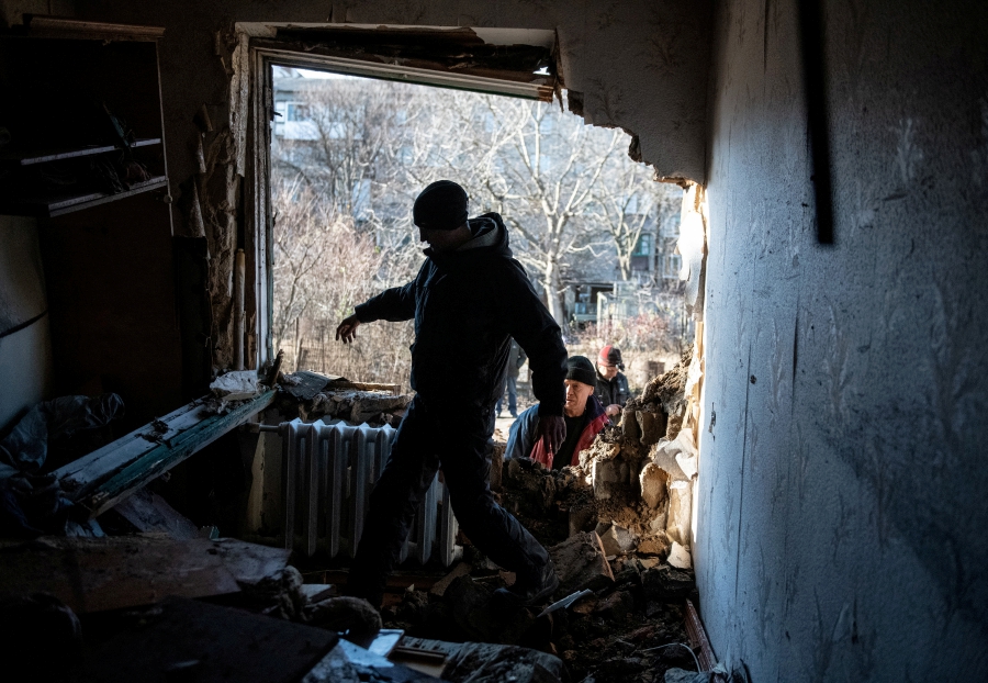 A local resident walks inside an apartment damaged by recent shelling in the course of Russia-Ukraine conflict in Donetsk, Russian-controlled Ukraine. (REUTERS/Stringer)
