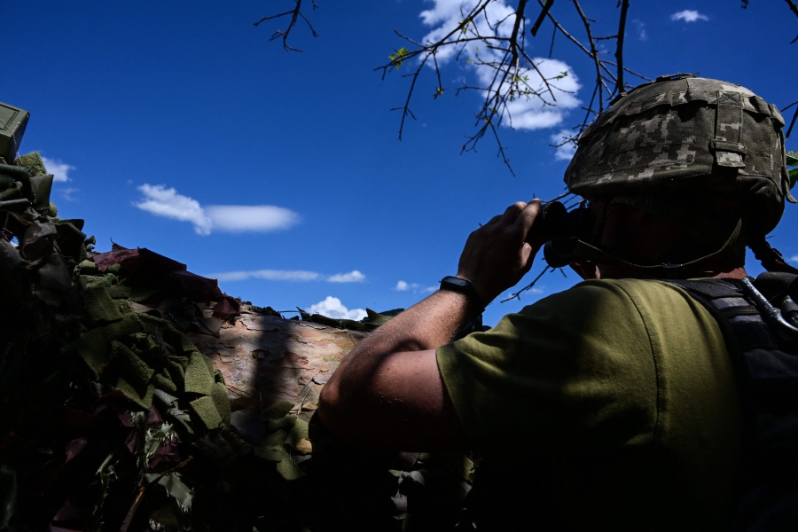 Ukrainian soldier is pictured in a trench near the front line in eastern Ukraine, on July 13, 2022, amid the Russian invasion of Ukraine. (Photo by MIGUEL MEDINA / AFP)