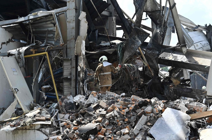 Rescuers clear rubbles of the Amstor mall in Kremenchuk, on June 28, 2022, one day after it was hit by a Russian missile strike according to Ukrainian authorities. - A Russian missile strike on a crowded mall in central Ukraine killed at least 18 people in what Group of Seven leaders branded "a war crime" at a meeting in Germany where they looked to step up sanctions on Moscow. The leaders vowed that Russian President and those responsible would be held to account for June 27's strike in the city of Kremenchuk, carried out during the shopping mall's busiest hours. - AFP pic