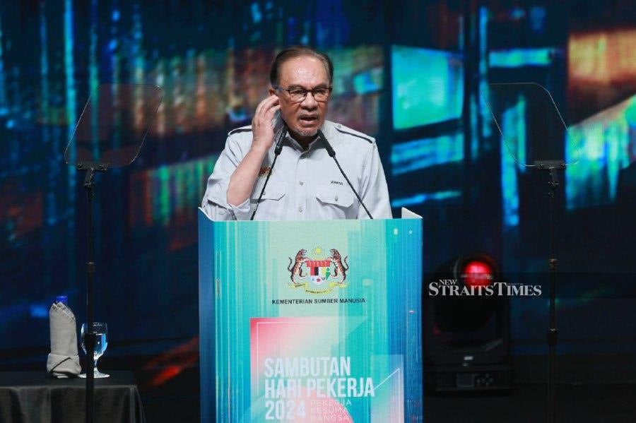 Prime Minister Datuk Seri Anwar Ibrahim delivers his keynote address during the Labour Day celebration at the Putrajaya International Convention Centre. -NSTP/ASYRAF HAMZAH
