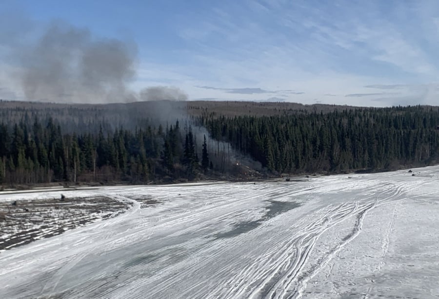 Smoke rising from the site of a plane crash outside Fairbanks, Alaska, after a Douglas DC-4 crashed into the Tanana River after taking off from Fairbanks International Airport. (Photo by Alaska State Troopers / AFP) 