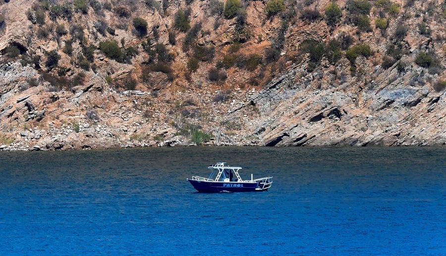 A patrol boat is seen on Lake Piru in the Los Padres National Forest, Ventura County, California on July 9, 2020 as the search continues for actress Naya Rivera, who was reported missing after going boating with her son on July 8. - "Glee" star Naya Rivera is missing and feared drowned at a California lake, where divers, patrol boats and helicopters resumed their search for the US actress on June 9. (Photo by Frederic J. BROWN / AFP)