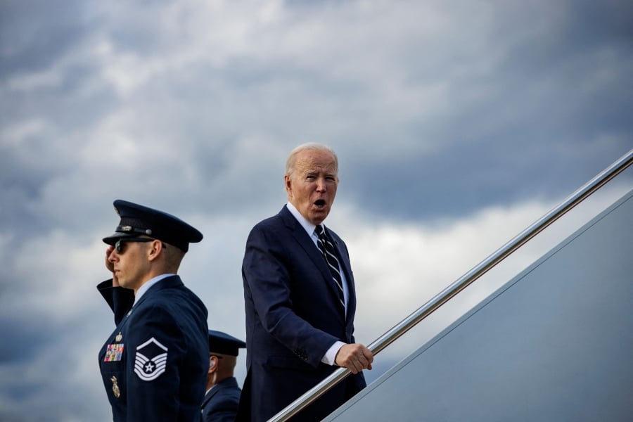 US President Joe Biden shouts to respond to a question from reporters as he boards Air Force One at Joint Base Andrews in Maryland as he departs for Rehoboth, Delaware, where he will spend the weekend. (Photo by SAMUEL CORUM / AFP)