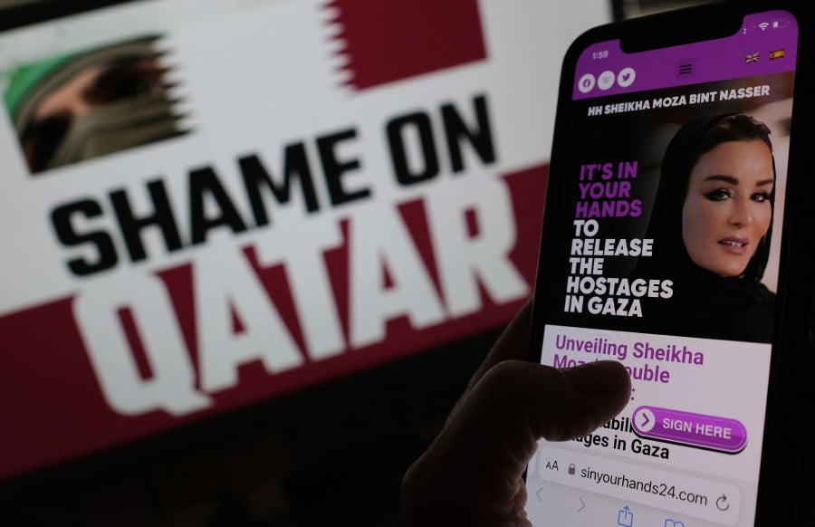 This illustration image created on June 7, 2024 in Los Angeles, shows anti-Qatar websites on a computer and smartphone screen. Shady websites call for a boycott of Qatar and vilify the Gulf state mediating between Israel and Hamas. AFP