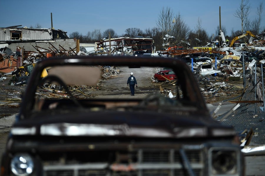 Tornado damage is seen after extreme weather hit the region December 12, 2021, in Mayfield, Kentucky. - Dozens of devastating tornadoes roared through five US states overnight, leaving more than 80 people dead Saturday in what President Joe Biden said was "one of the largest" storm outbreaks in history. - AFP pic