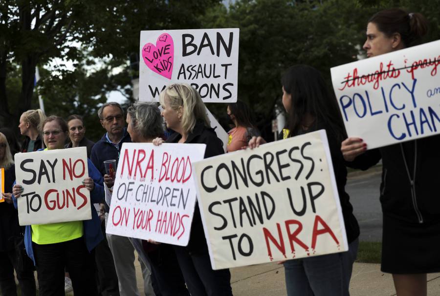 Gun-control advocates hold a vigil outside of the National Rifle Association (NRA) headquarters following the recent mass shooting at Robb Elementary School on May 25, 2022 in Fairfax, Virginia. - AFP Pic