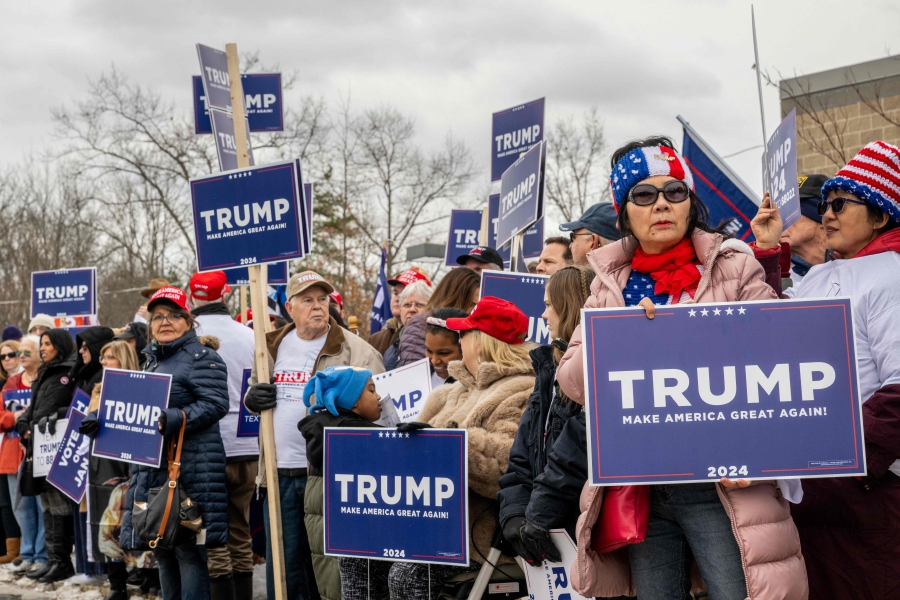 Trump supporters wait together ahead of Republican presidential candidate and former President Donald Trump's visit to the Londonderry High School polling station in Londonderry, New Hampshire. (Photo by Brandon Bell / GETTY IMAGES NORTH AMERICA / Getty Images via AFP)