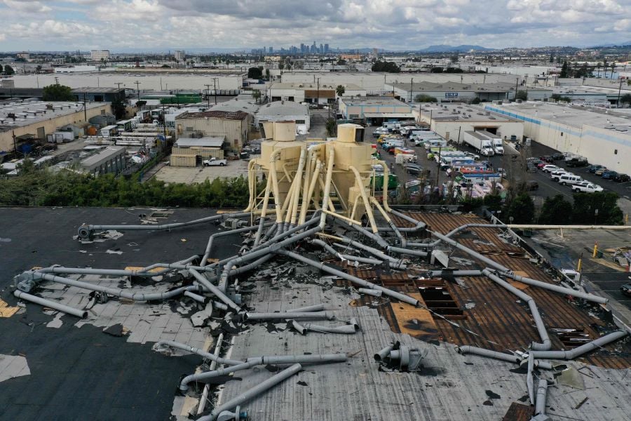 An aerial image shows damage to the roof of an industrial building from a tornado during a winter storm in Montebello, a city in Los Angeles County, California on March 23, 2023. - AFP Pic