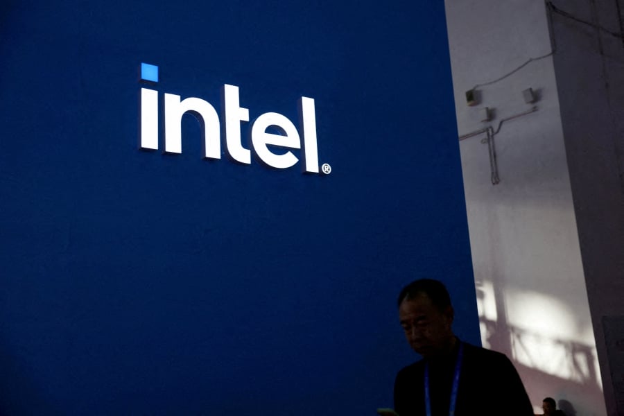 (FILE PHOTO) A man walks past the Intel logo at its booth during the first China International Supply Chain Expo (CISCE) in Beijing, China. (REUTERS/Florence Lo/File Photo)