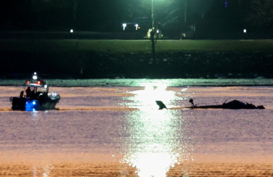 Rescuers on a boat work next to the wreckage of a Black Hawk helicopter at the site of the crash after it collided with the American Eagle flight 5342 which was approaching Reagan Washington National Airport and crashed into the Potomac River, outside Washington, US. REUTERS