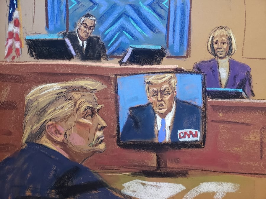 E. Jean Carroll testifies before Judge Lewis Kaplan as former U.S. President Donald Trump watches footage of himself appearing on a CNN Town Hall event, during the second civil trial where Carroll accused Trump of raping her decades ago, at Manhattan Federal Court in New York City, U.S. in this courtroom sketch. (REUTERS/Jane Rosenberg)