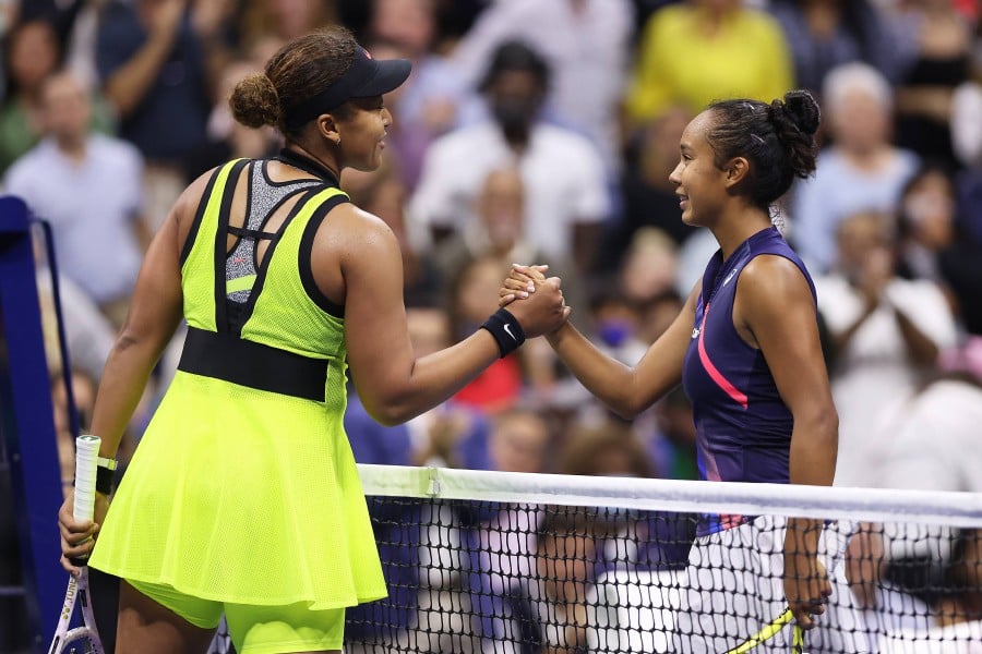 Leylah Fernandez (R) of Canada meets at the net after defeating Naomi Osaka (L) of Japan during her Women's Singles third round match on Day Five at USTA Billie Jean King National Tennis Center on September 03, 2021 in New York City. - AFP pic